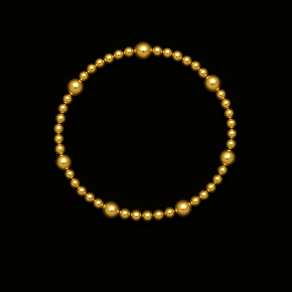 Gold beaded bracelet on a black background