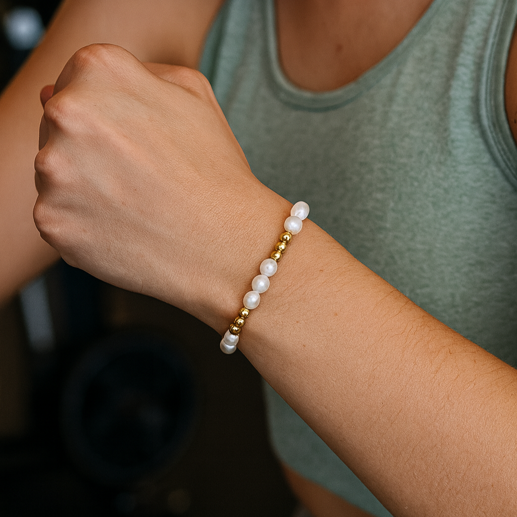 Person wearing a pearl bracelet on a blurred background