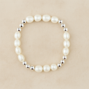 Pearl bracelet with silver beads on a beige background