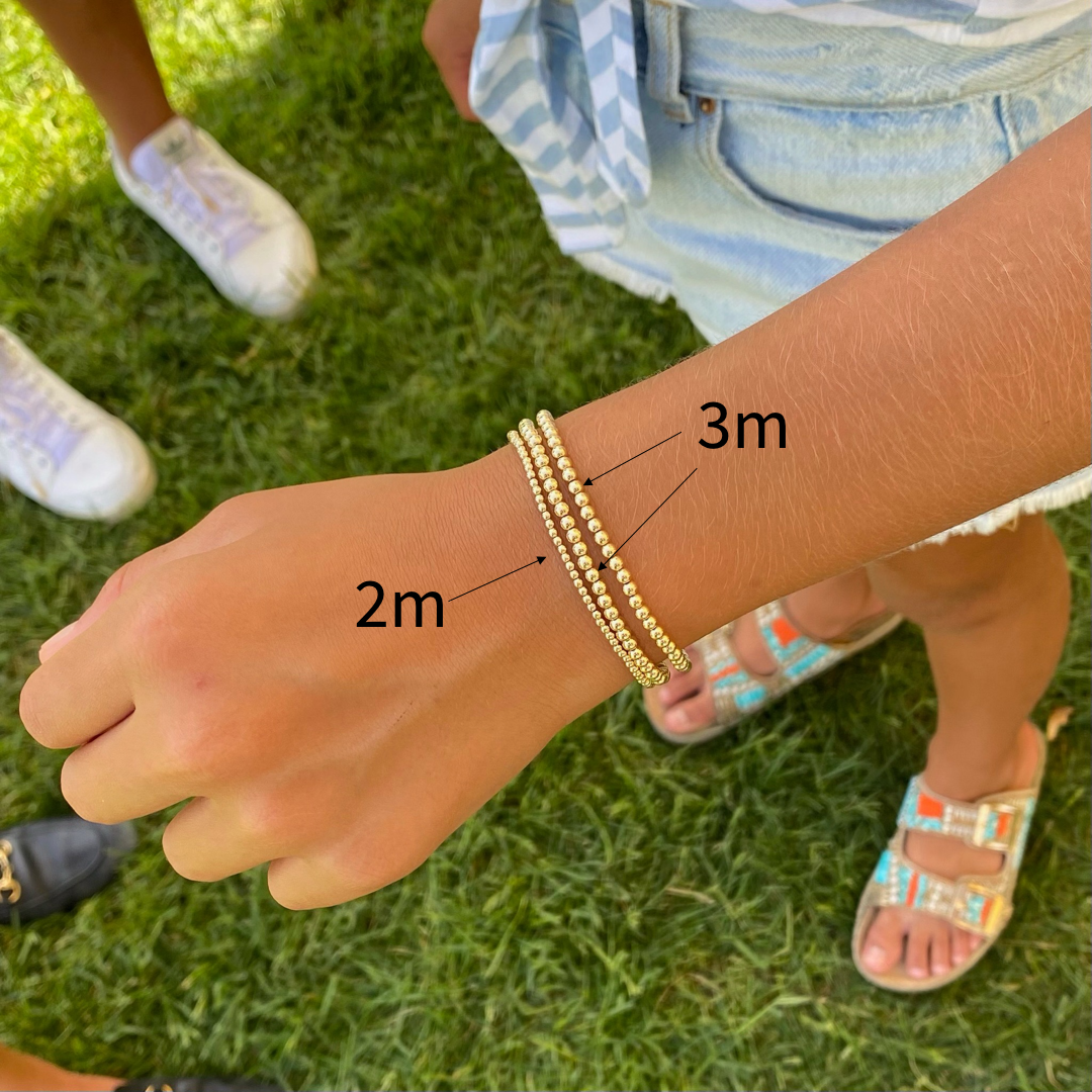 2mm vs 3mm gold ball bracelet on wrist