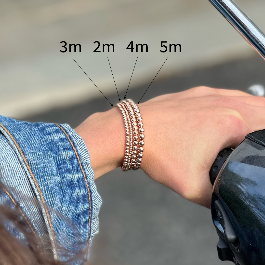 comparison of 2-5mm rose gold ball bracelets on wrist